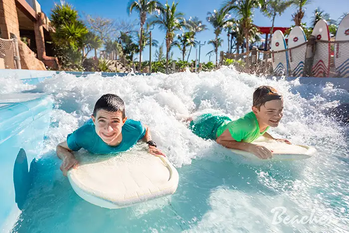 Two boys on the wave rider at Beaches Turks & Caicos