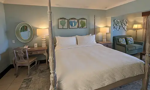 A Caribbean-themed bedroom at Sandals Grande Antigua (c)Sandals