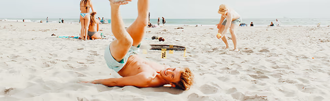 Young man goofing off on the beach