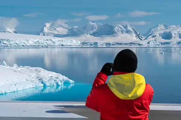 A traveler looks in the distance in Paradise Bay, Antarctica  (c)Hurtigruten