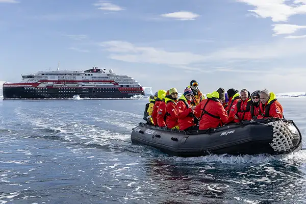 A zodiac departs a ship in Fournier Bay, Antarctica  (c)Hurtigruten