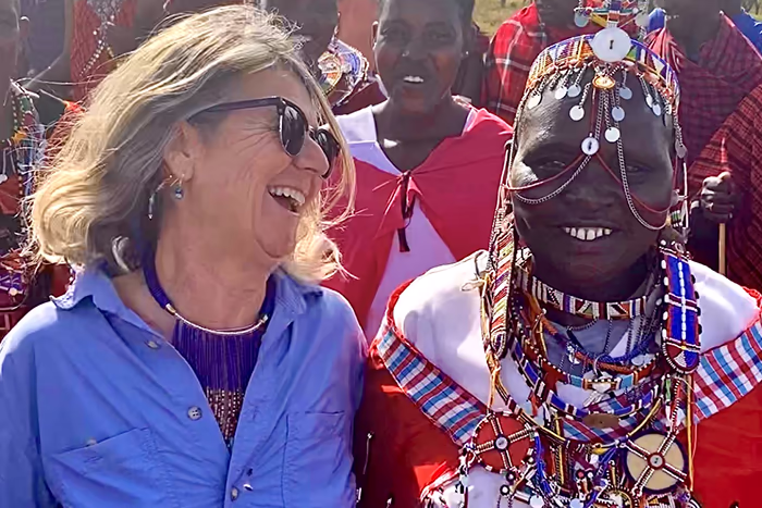 Woman laughs with Masaii Mari woman
