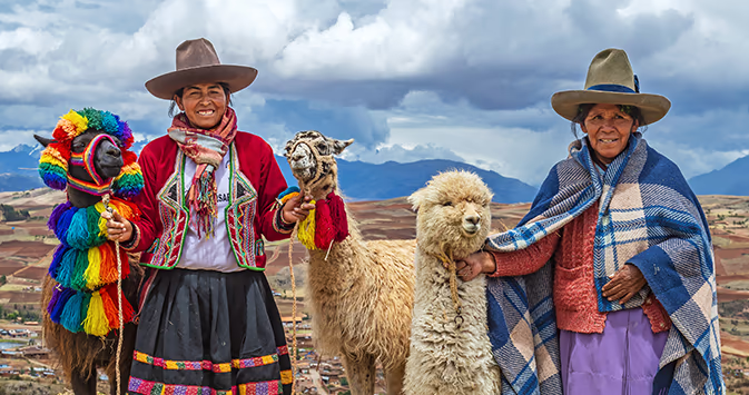Two local Peruvian women with llamas