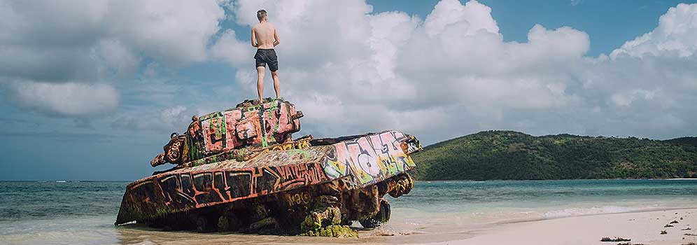 Man standing on tank on Flemenco Beach in Puerto Rico