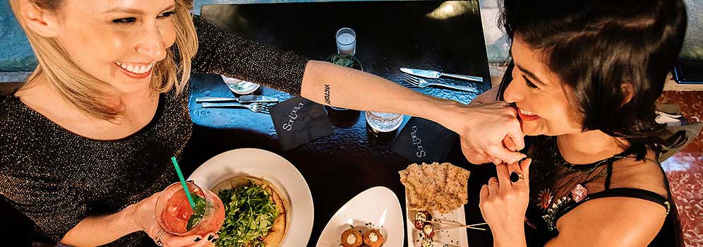 Lesbian couple enjoying dinner in San Juan