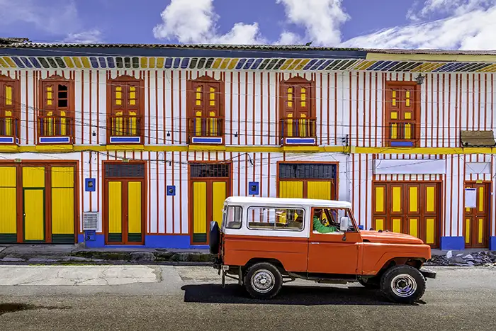 A car passing on the colourful street of Tolima Colombia the little town in a sunny day.