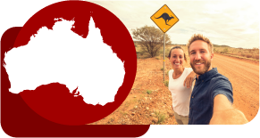 man and woman taking a selfie in australia in front of a kangaroo sign