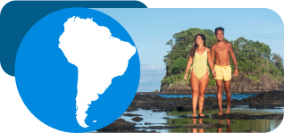 man and woman walking on a costa rica beach